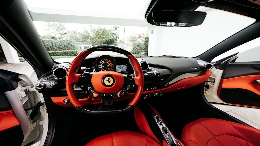 Red car steering wheel and interior — hi-tech brake pedal lock vs steering wheel locks
