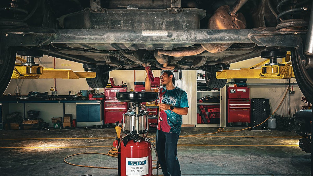 Mechanic working under a car — catalytic converter theft