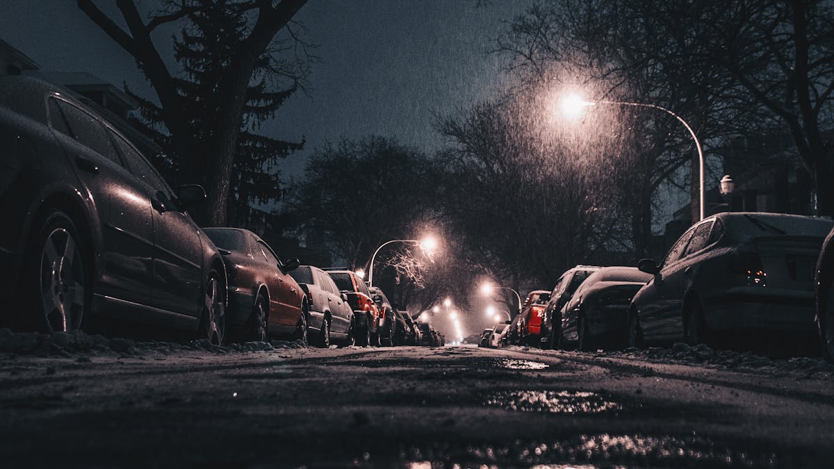 Cars parked on a city street at night — car theft risk in America