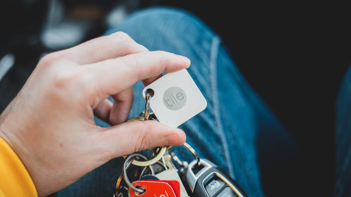 Person holding a car key — layered vehicle security to prevent theft