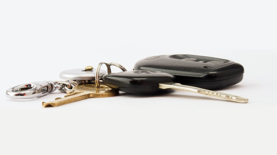 Car keys on a white surface — choosing an anti-theft vehicle device